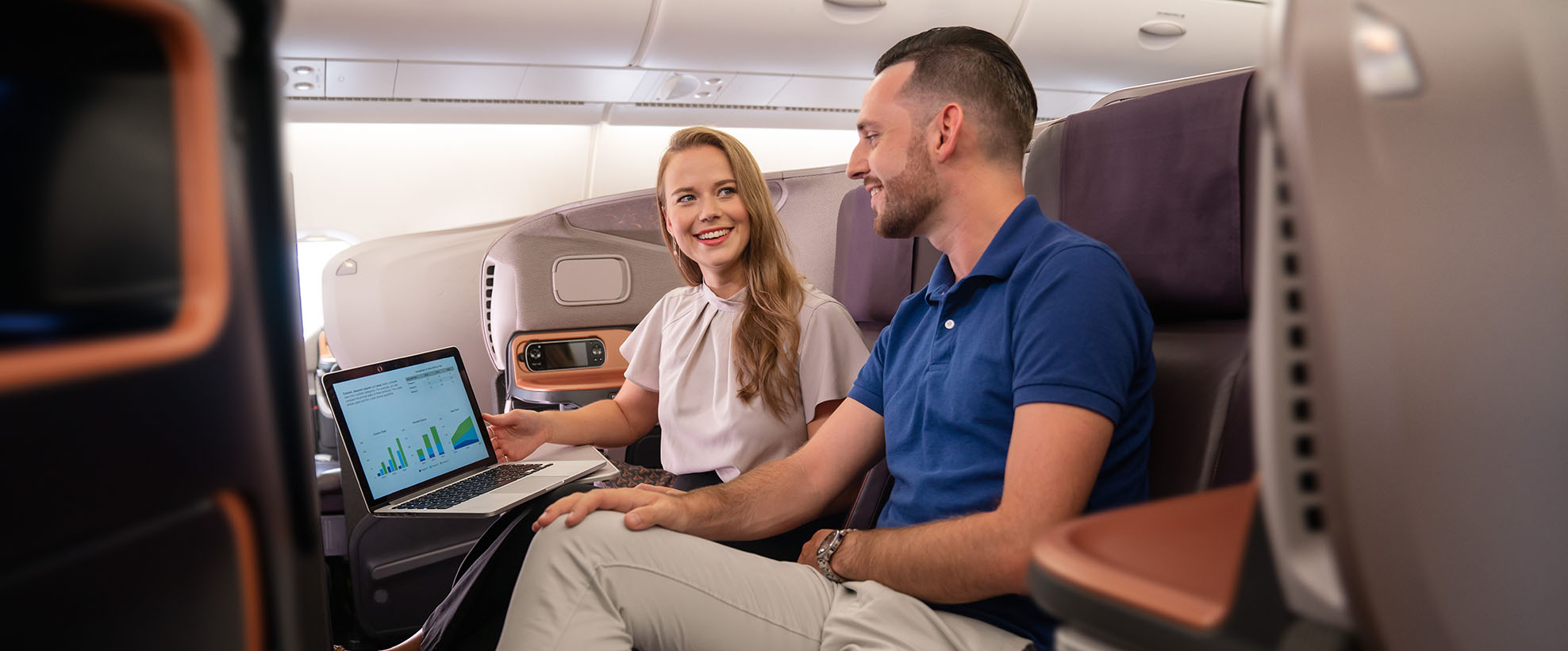 Man and woman talking in Singapore Airlines Business Class